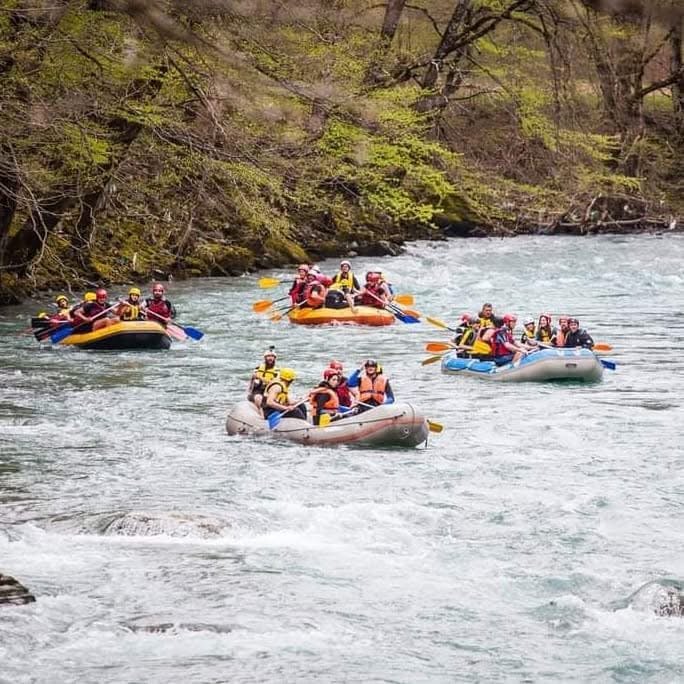 Rafting boat splashing through white water