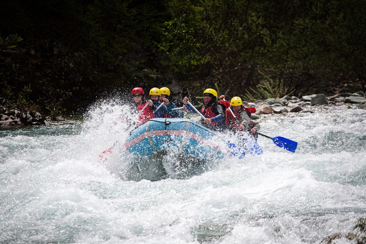 Rafting boat splashing through white water